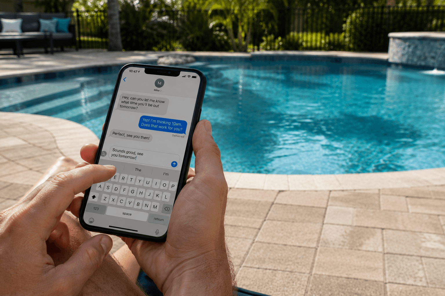 Pool owner texting Clear Choice Pools for fast help from a poolside lounger